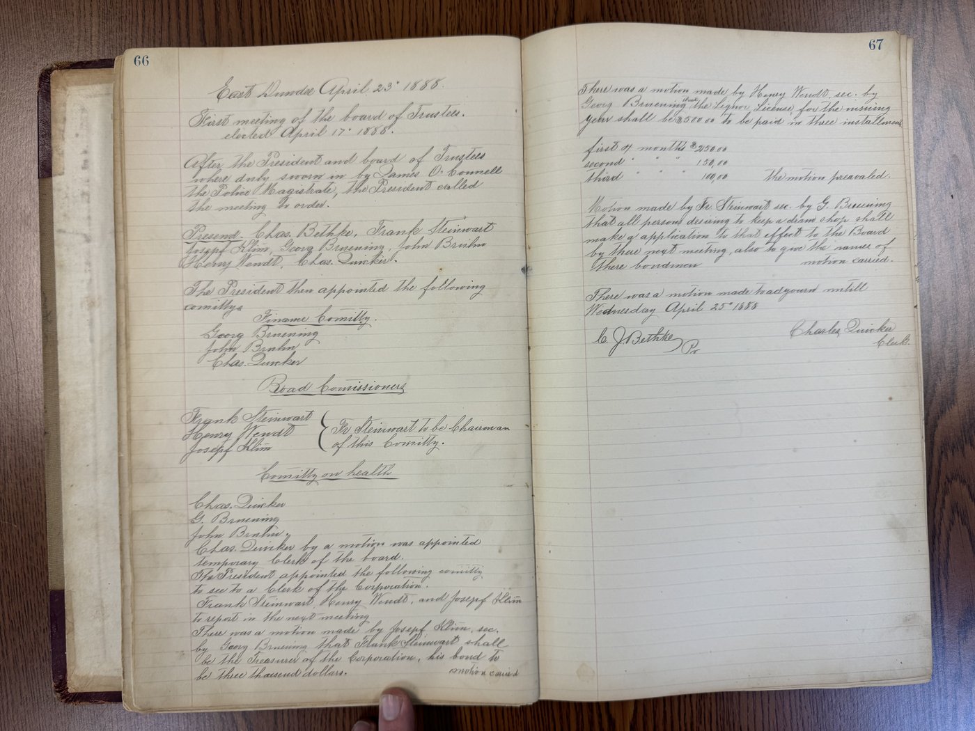 Handwritten pages 66-67 of the Record Book, recording the first meeting of the newly elected Board of Trustees on April 23, 1888